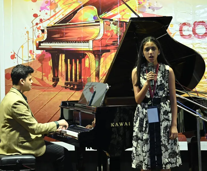 A student at the piano accompanying a student singer at Confluence 2025